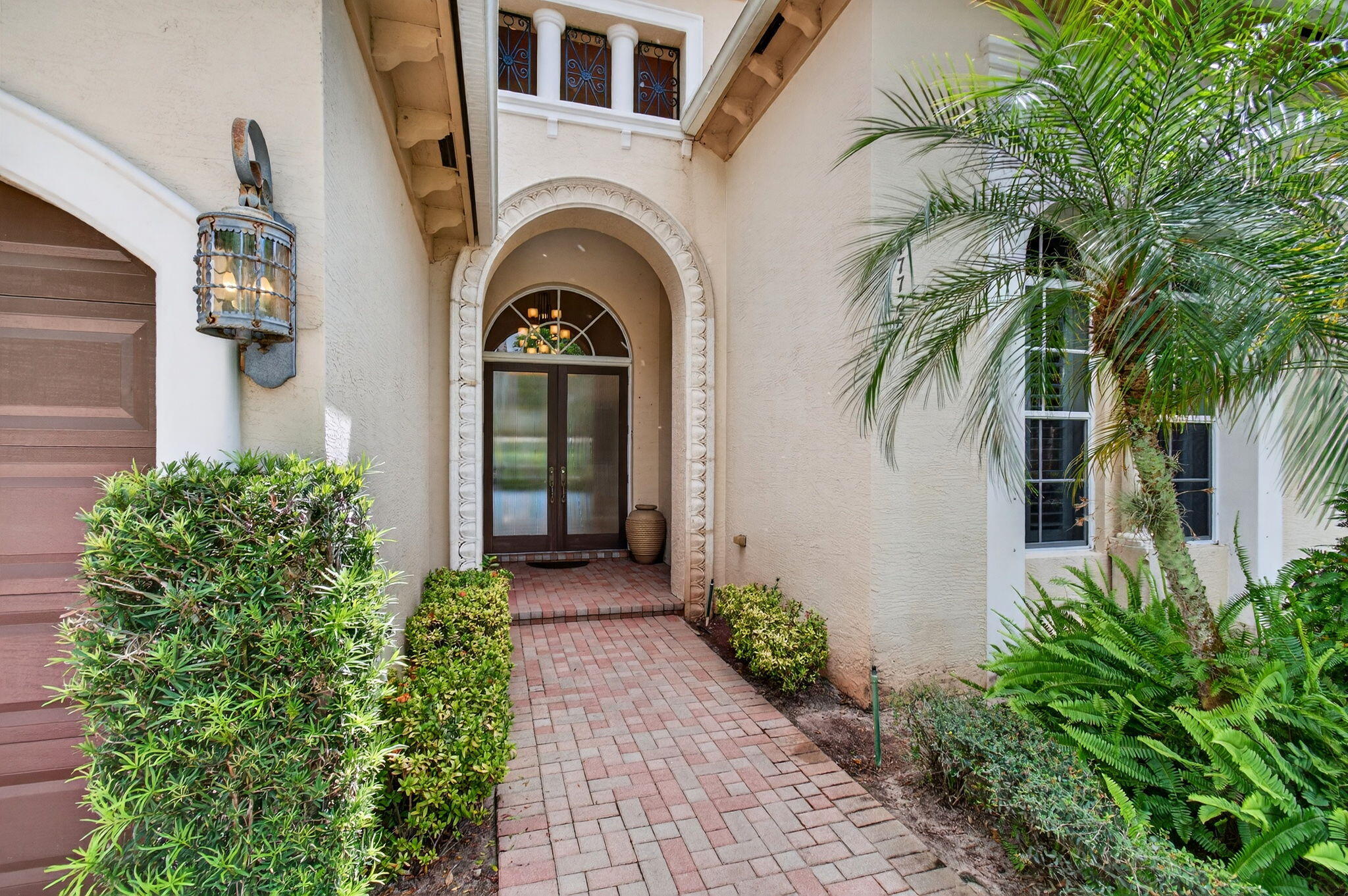 17728 Villa Club Way Boca Raton, FL 33496 - Photo 2 of 36 a front view of a house with a garden