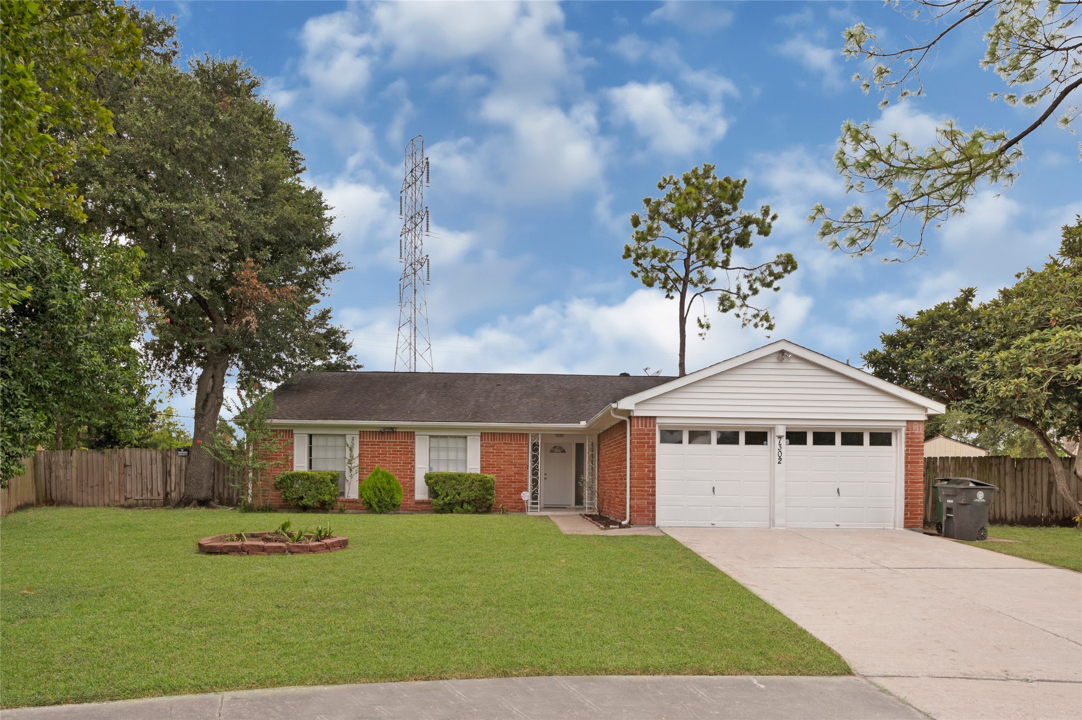 7302 Redding Road Houston, TX 77036 - Photo 1 of 26 a front view of a house with a yard and garage