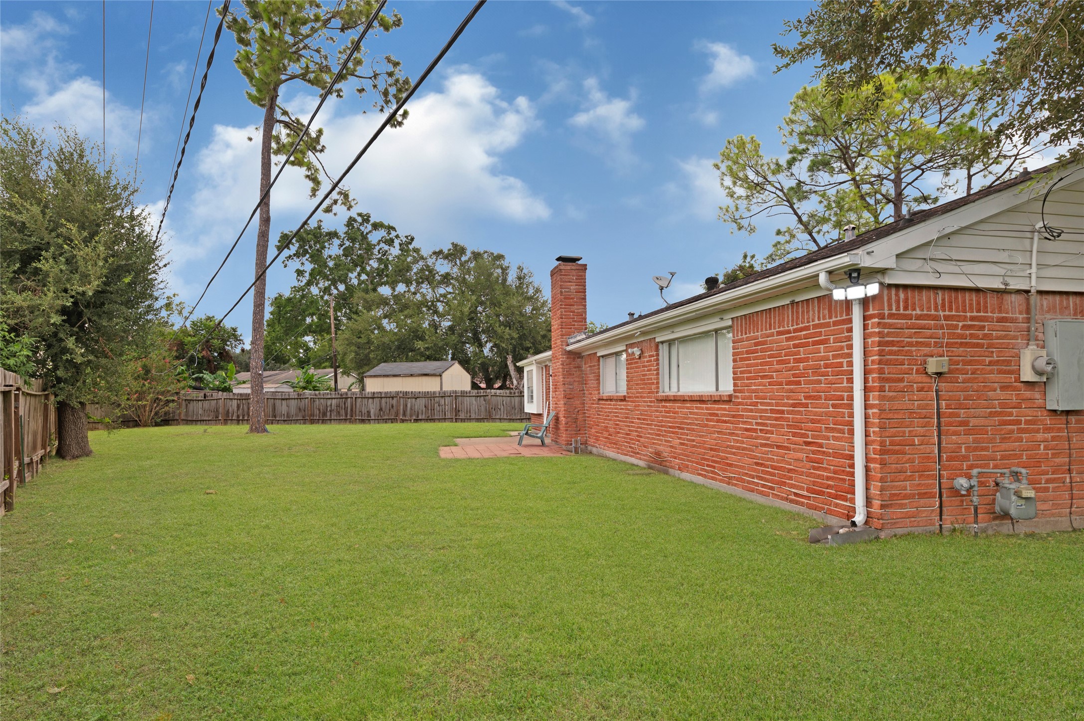 7302 Redding Road Houston, TX 77036 - Photo 15 of 26 a view of a backyard with a large tree