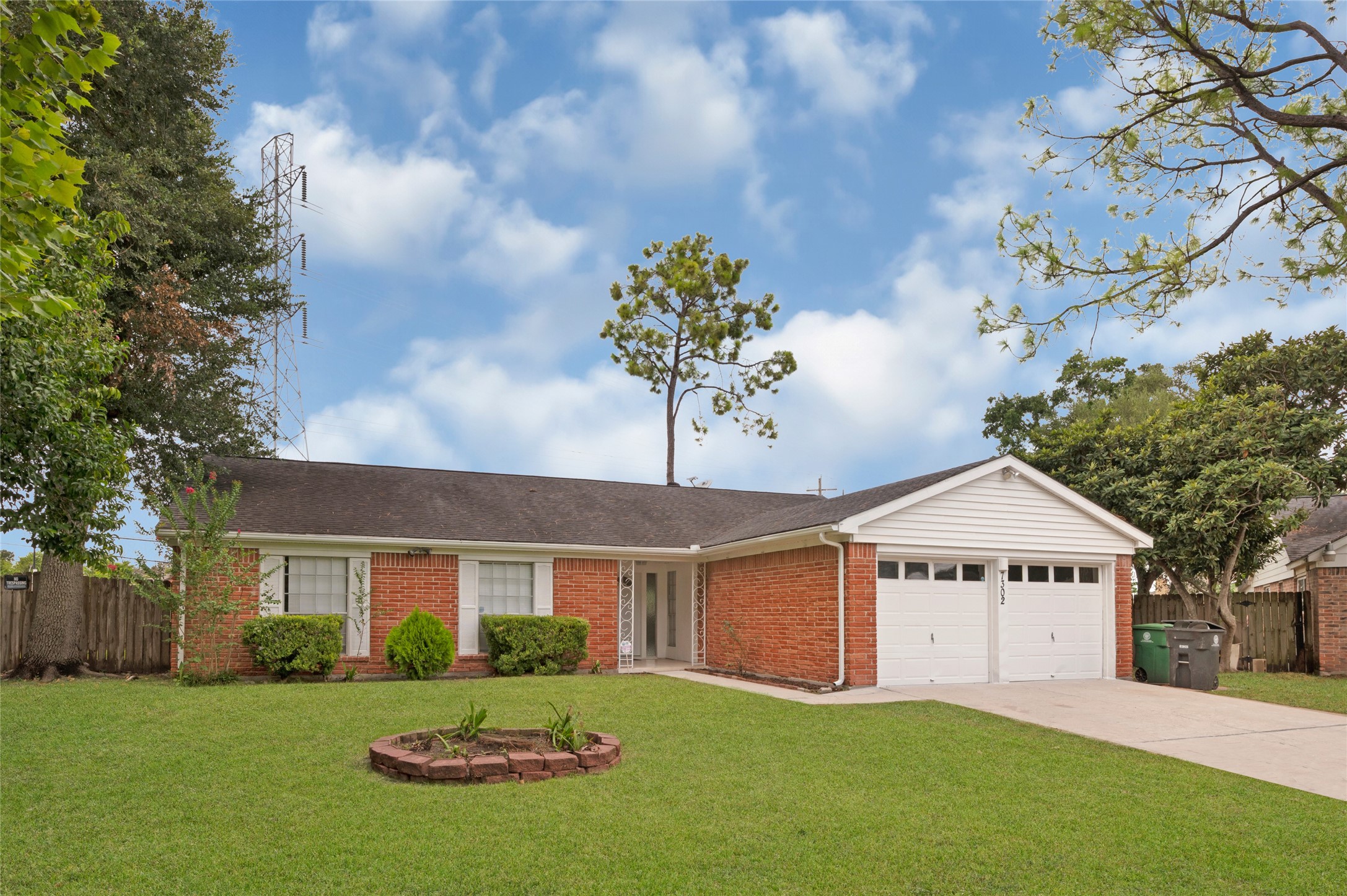 7302 Redding Road Houston, TX 77036 - Photo 2 of 26 a front view of a house with a yard and garage