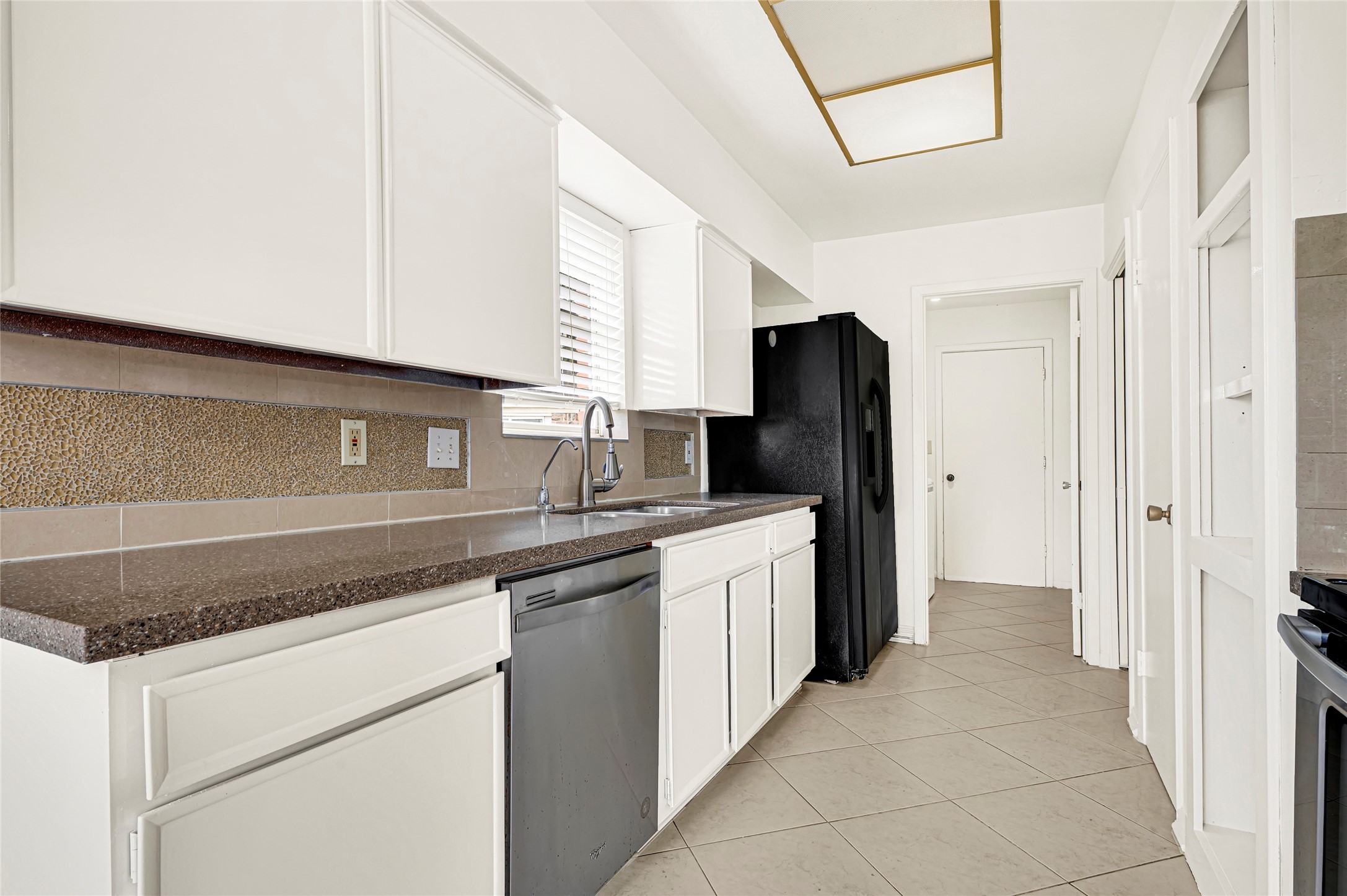 7302 Redding Road Houston, TX 77036 - Photo 21 of 26 a kitchen with stainless steel appliances granite countertop a refrigerator and a sink