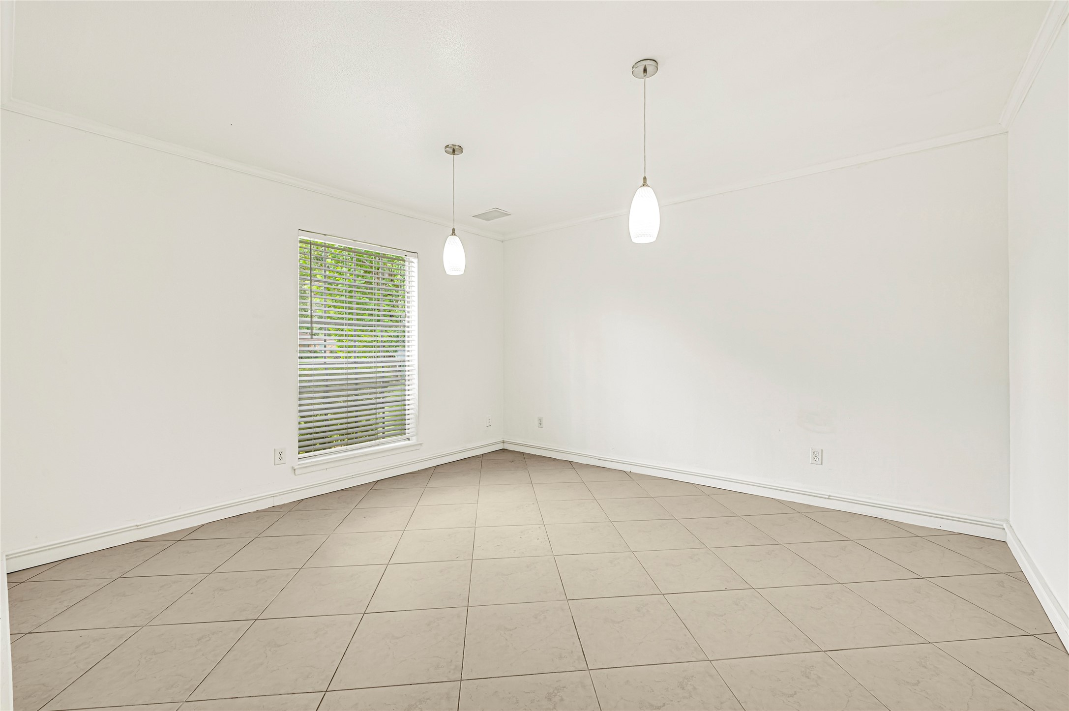 7302 Redding Road Houston, TX 77036 - Photo 5 of 26 a view of an empty room with a window