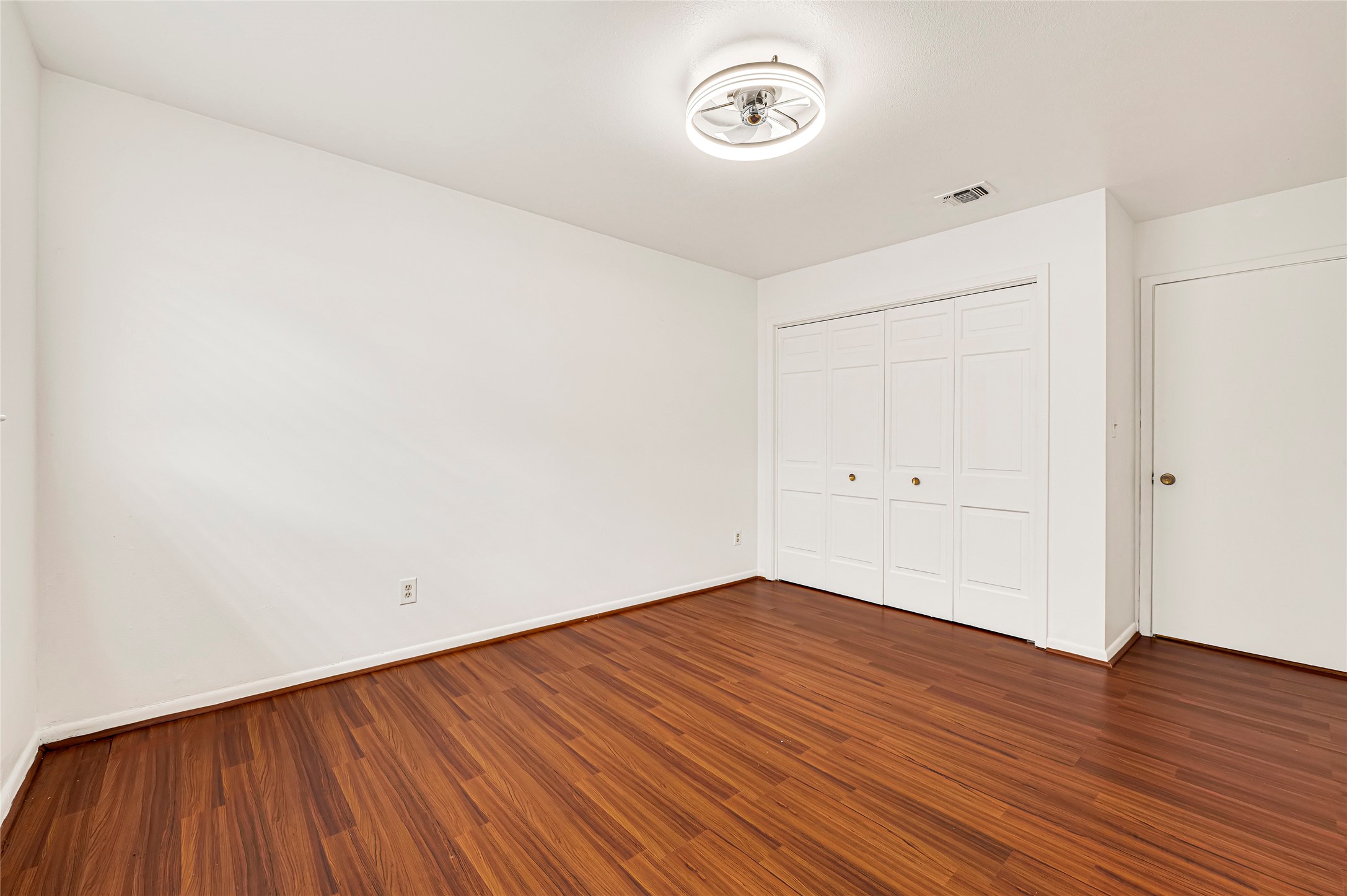 7302 Redding Road Houston, TX 77036 - Photo 8 of 26 an empty room with wooden floor