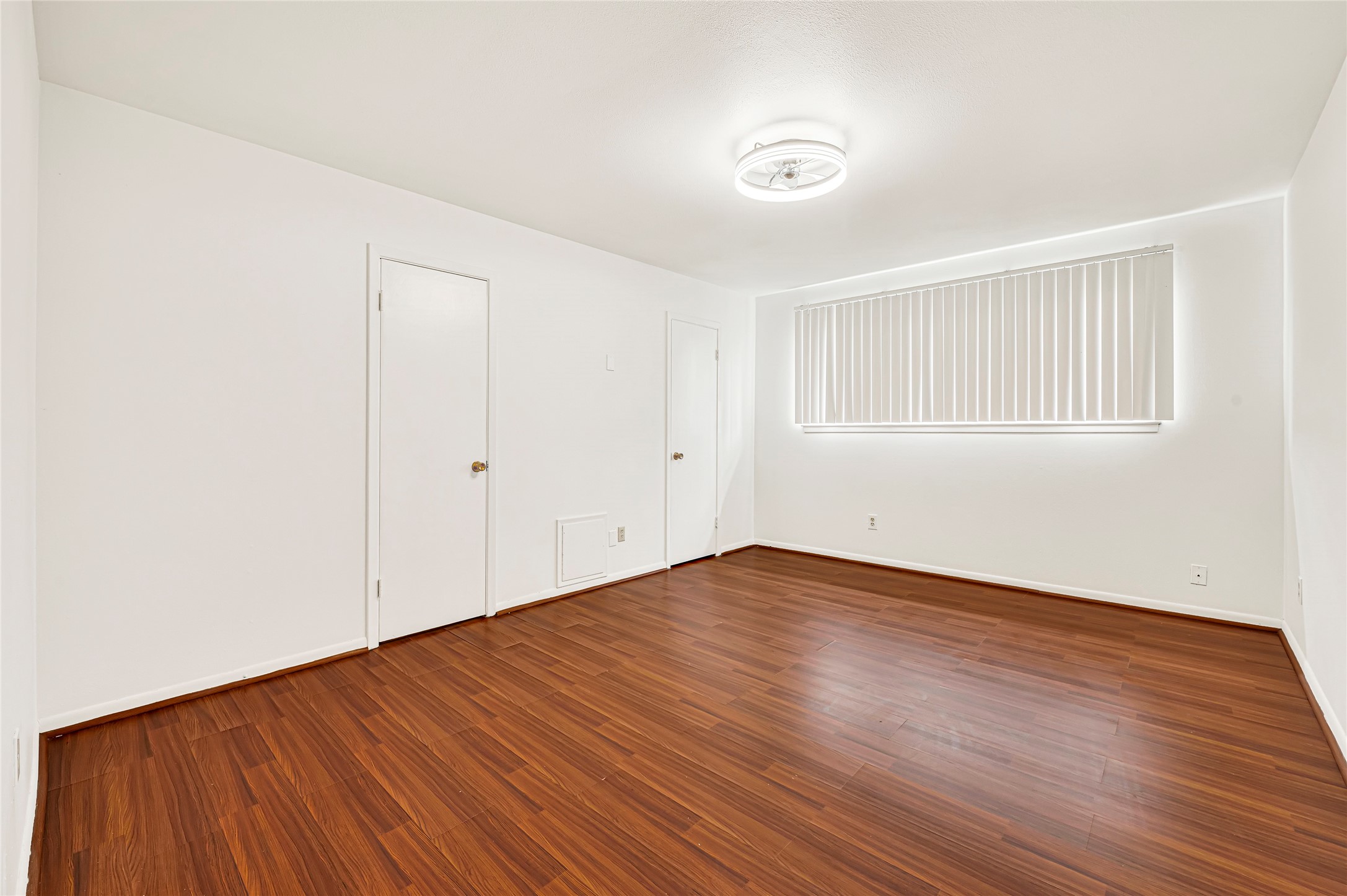 7302 Redding Road Houston, TX 77036 - Photo 9 of 26 a view of an empty room with wooden floor and a window