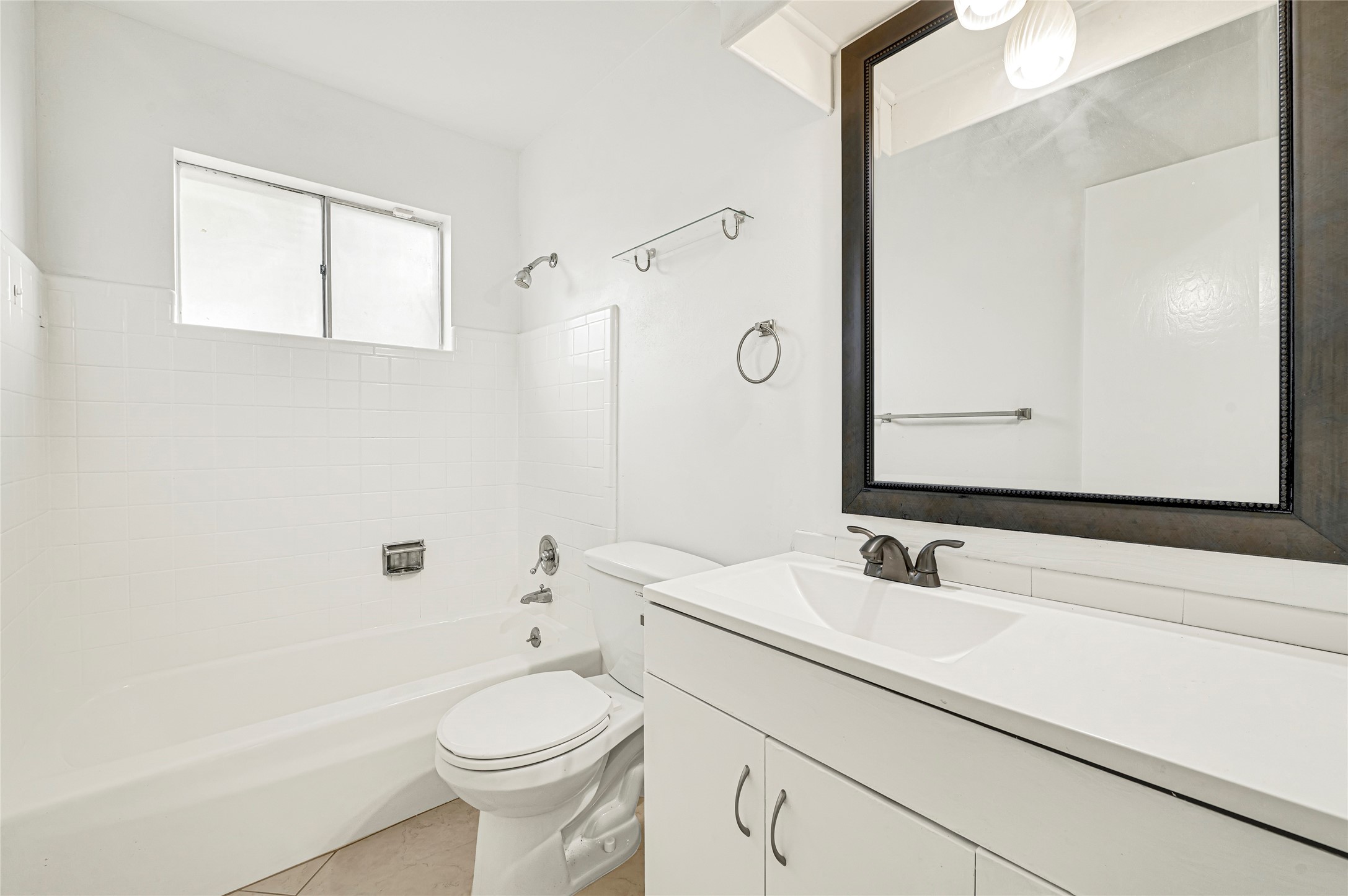 7302 Redding Road Houston, TX 77036 - Photo 10 of 26 a bathroom with a sink a toilet and shower