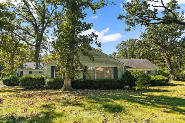 a view of a house with a tree in a yard