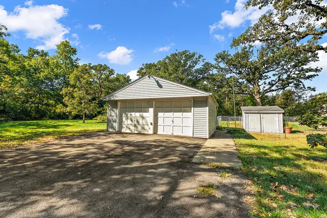a view of a house with backyard and a garden