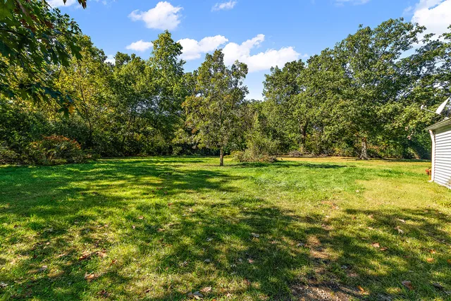 a view of outdoor space with deck and yard