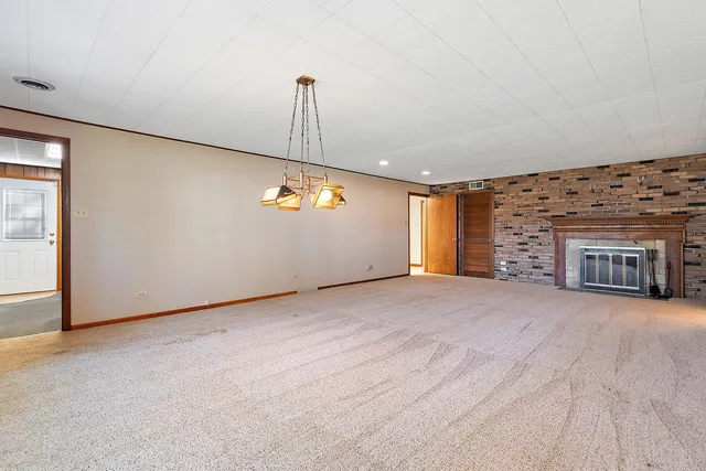 a view of an empty room with a fireplace