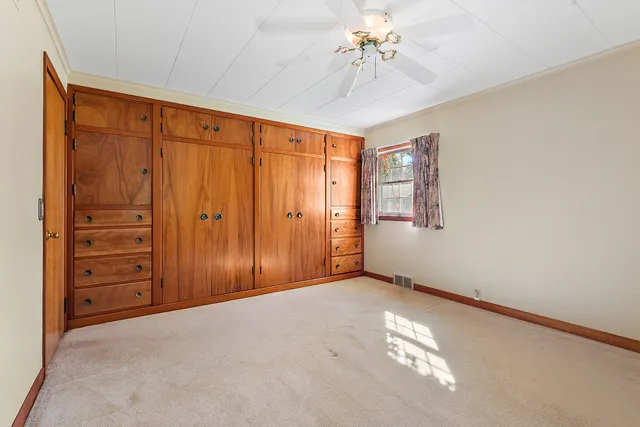 an empty room with windows and closet