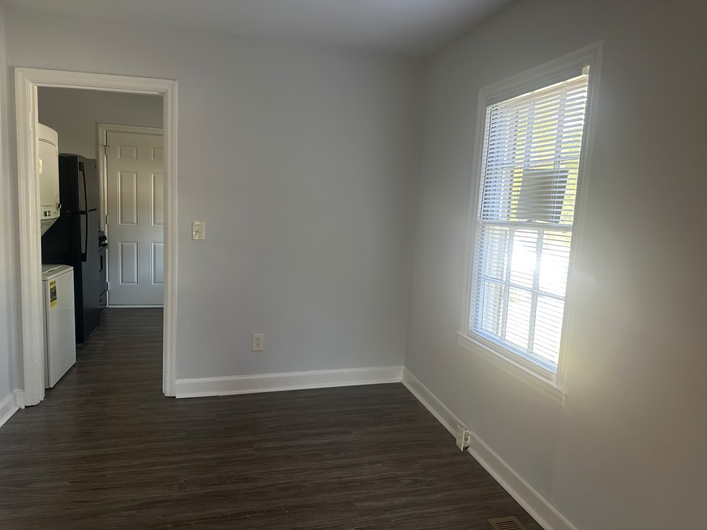 5636 Hunter Road Columbus, GA 31907 - Photo 5 of 10 a view of an empty room with wooden floor and a window