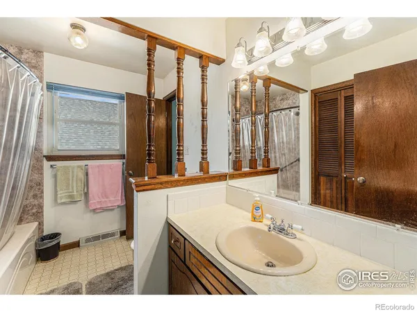 a bathroom with a sink a vanity and a mirror
