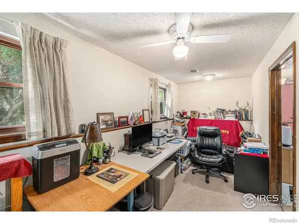 a living room with furniture a flat screen tv and a window