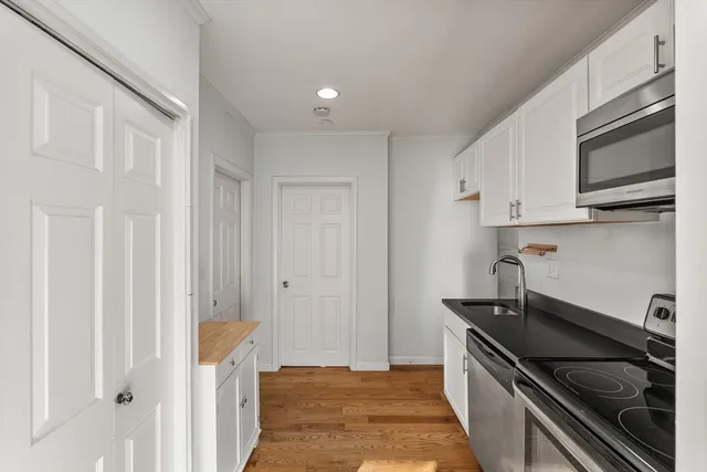 a kitchen with stainless steel appliances a stove and a refrigerator