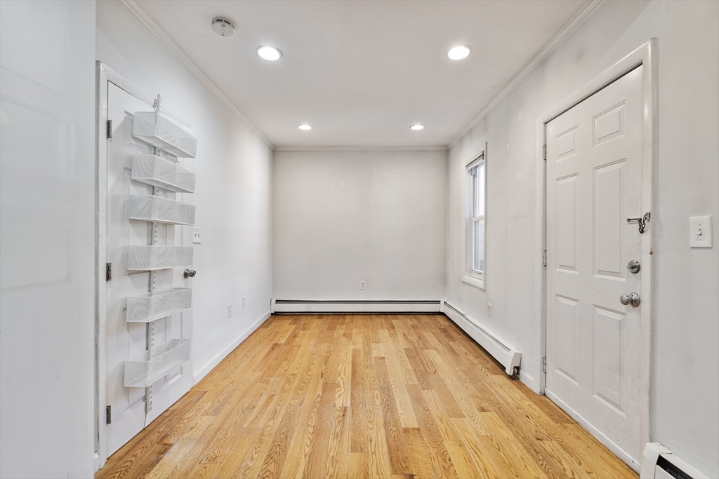 7 Burrill Place, Unit 1 Boston, MA 02127 - Photo 4 of 7 a view of a hallway with wooden floor and a bathroom