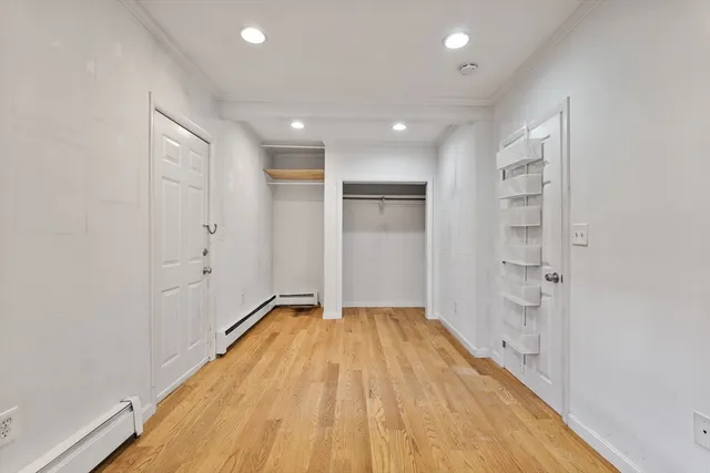 a view of a room with wooden floor and bathroom