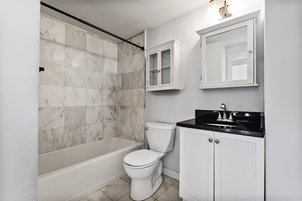 7 Burrill Place, Unit 1 Boston, MA 02127 - Photo 6 of 7 a bathroom with a sink a toilet and bathtub