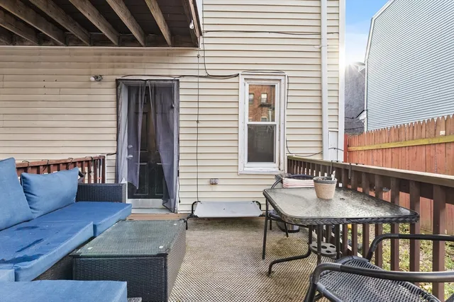 a balcony with table and chairs