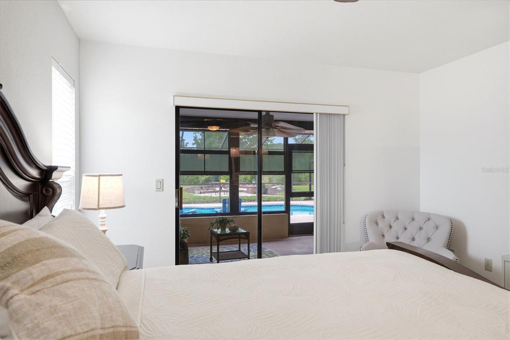 5227 Suwannee Road Weeki Wachee, FL 34607 - Photo 24 of 62 a bedroom with a bed and a large window