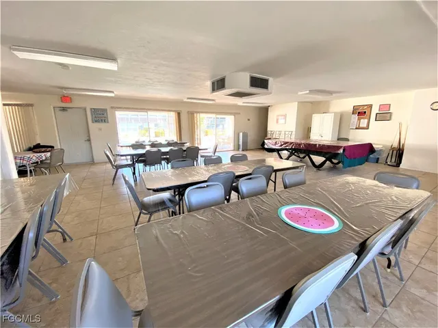 a living room with lots of furniture and view of kitchen