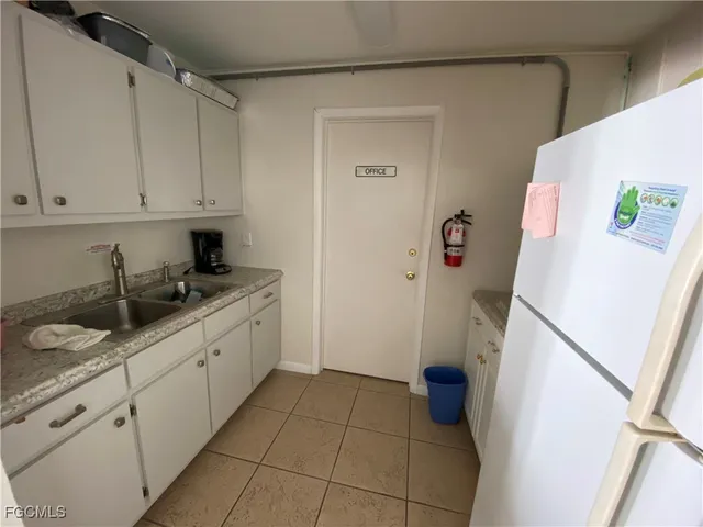 a living room with stainless steel appliances kitchen island granite countertop furniture and a view of kitchen