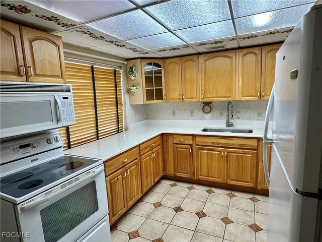 a kitchen with a cabinets and white appliances