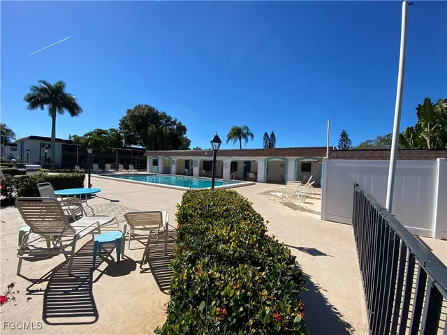 a view of a house with backyard and sitting area