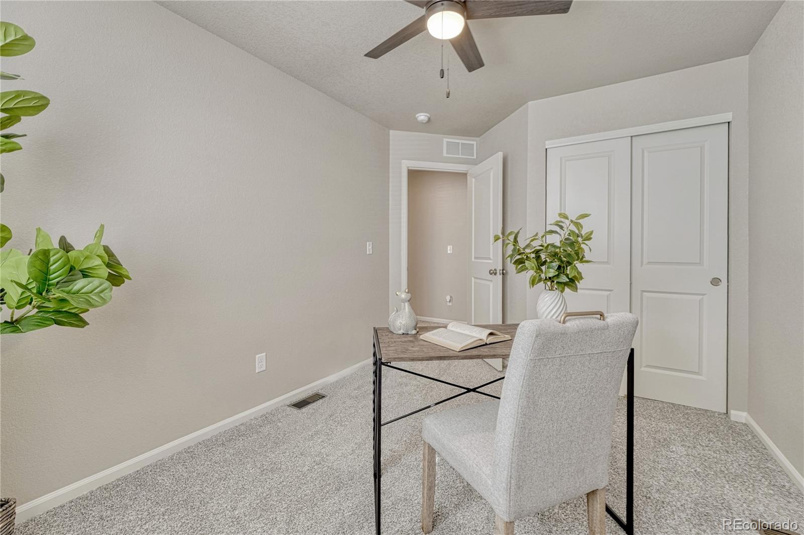 5861 Dakan Loop Colorado Springs, CO 80927 - Photo 21 of 29 a dining room with furniture and a potted plant