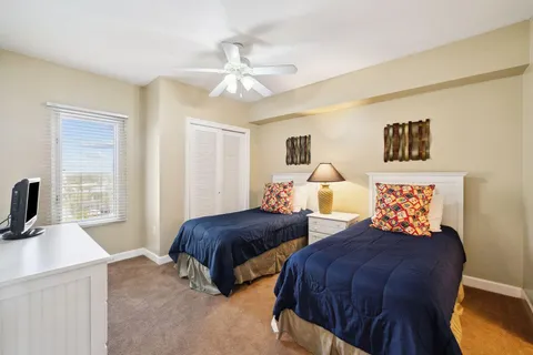 a bedroom with two beds and a window