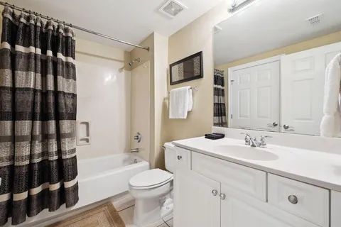 a bathroom with a sink toilet a shower and a mirror