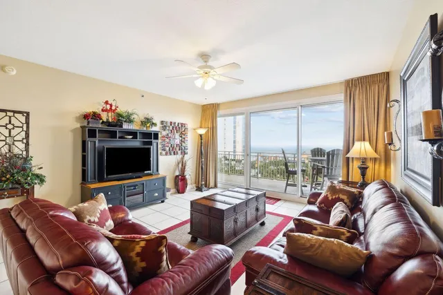a living room with furniture a flat screen tv and a large window
