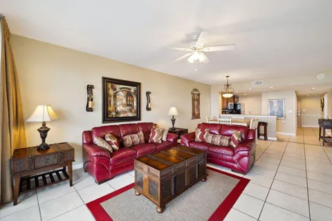 a living room with furniture and a lamp