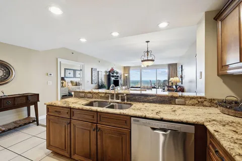 a kitchen with granite countertop a sink and a stove