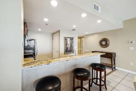 a kitchen with stainless steel appliances granite countertop a stove a sink and a microwave