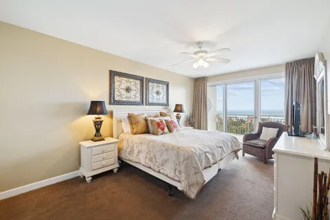 a bedroom with a bed furniture and a large window