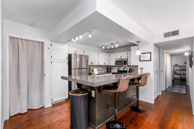 a kitchen with stainless steel appliances granite countertop a sink and stove top oven
