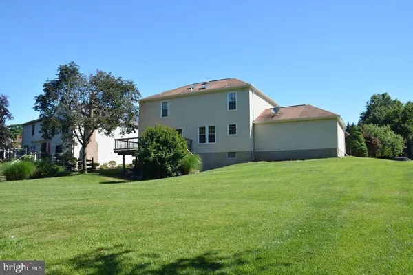 a front view of house with yard and green space