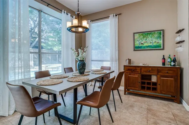 a view of a dining room with furniture wooden floor and chandelier