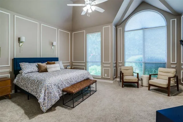 a spacious bedroom with a bed and a couch