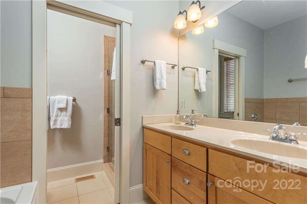 7 Fitzgerald Road Black Mountain, NC 28711 - Photo 13 of 23 a bathroom with a shower sink vanity and mirror