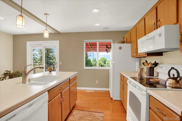 a kitchen with granite countertop a sink a counter top space and cabinets