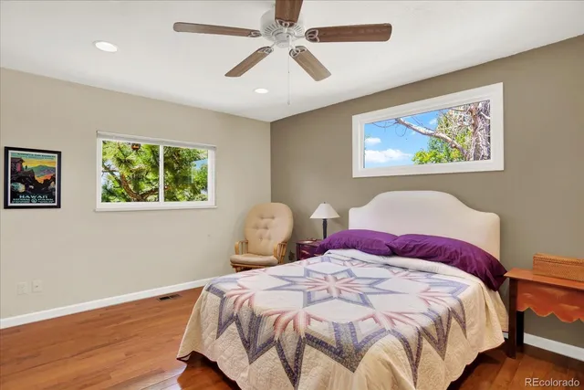a bedroom with bed and wooden floor