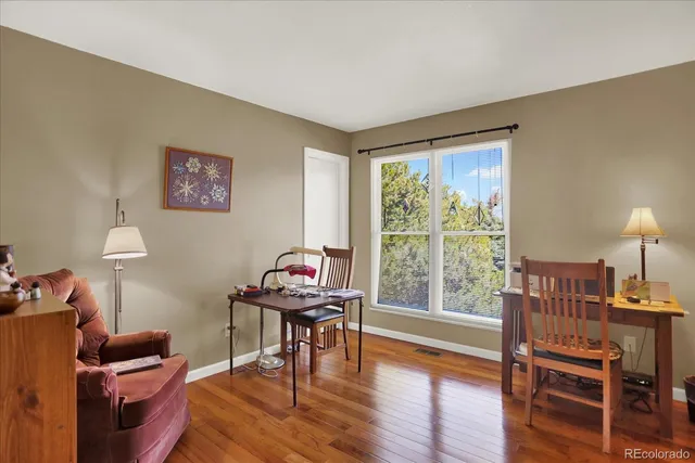 a livingroom with workspace and a window
