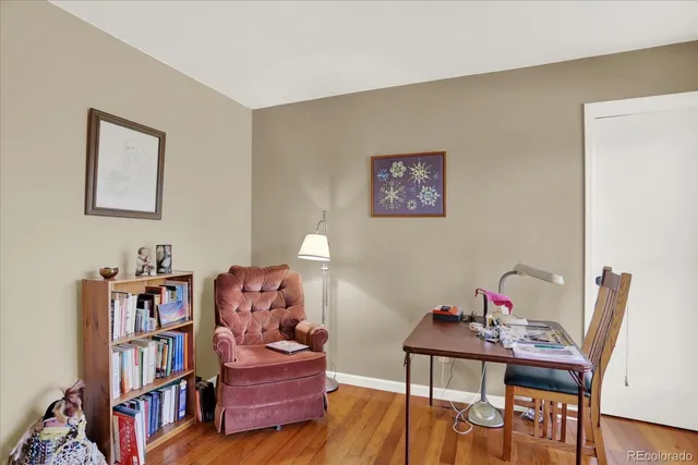a living room with furniture and a book shelf