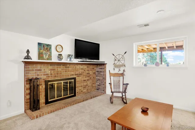 a living room with fireplace furniture and a flat screen tv