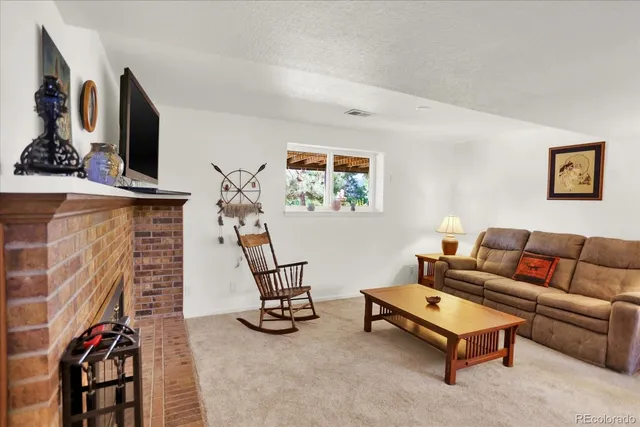 a living room with furniture a couch and a flat screen tv