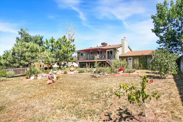 a view of a house with swimming pool and sitting area