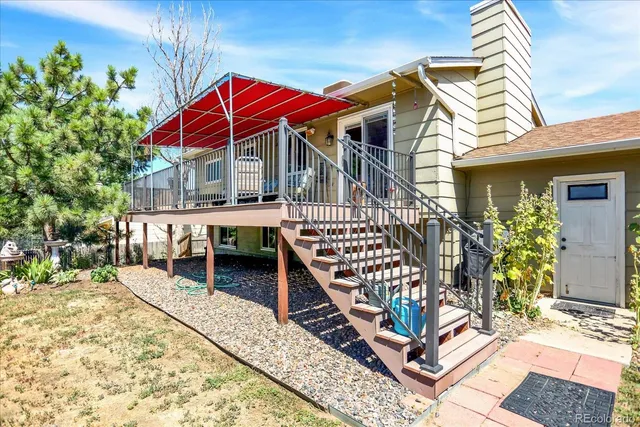 a view of a house with wooden deck