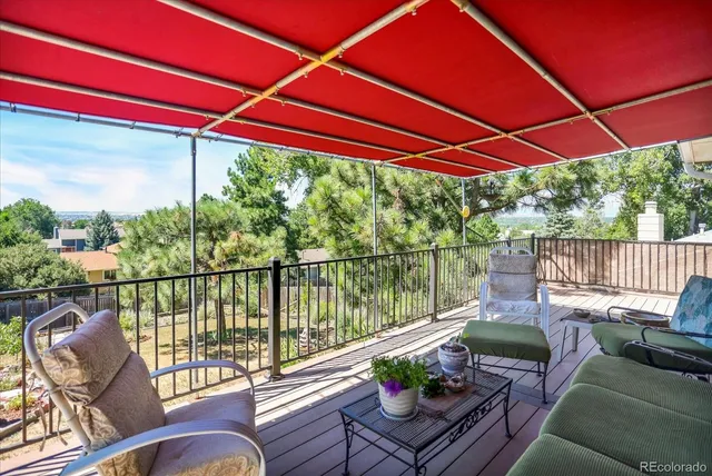 a balcony with furniture and wooden floor