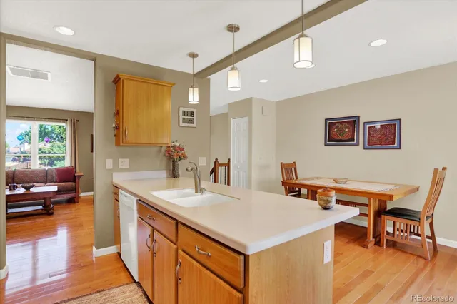 a view of a kitchen counter space and dining room